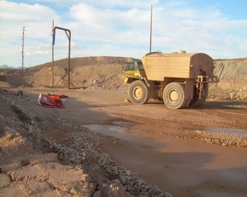 Crushed porta-john shown on left and water truck on right