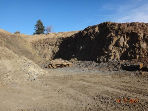 Bulldozer crumpled in pit from fall
