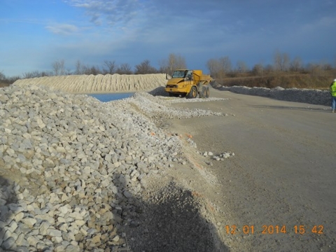 Edge of a roadway berm which was crossed by a haul truck as it ran into the water