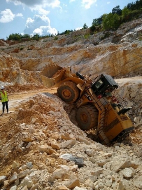 Close call alert a front loader backed over a highwall