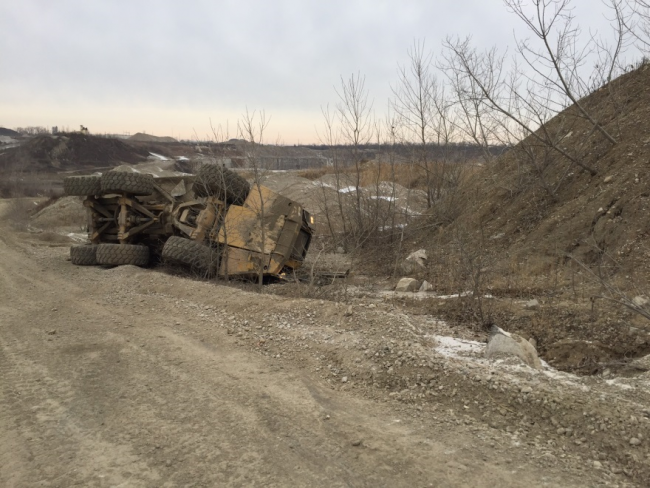 Haul truck turned on side