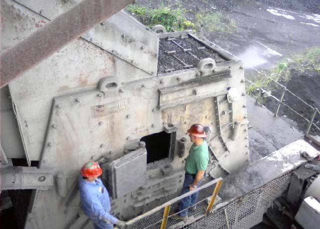 Two miners looking into a hatch