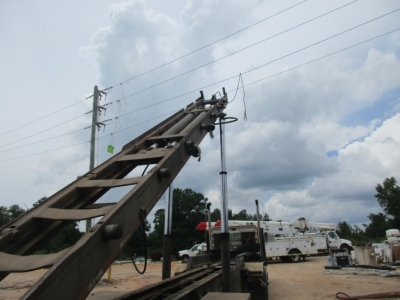 Accident scene where a truck driver was using a roll-off truck with a winch attachment to pick up a construction dump bin