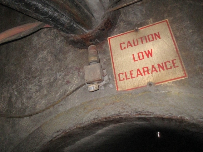 Operating a locomotive underground, a miner hit his head on a low clearance ventilation bulkhead