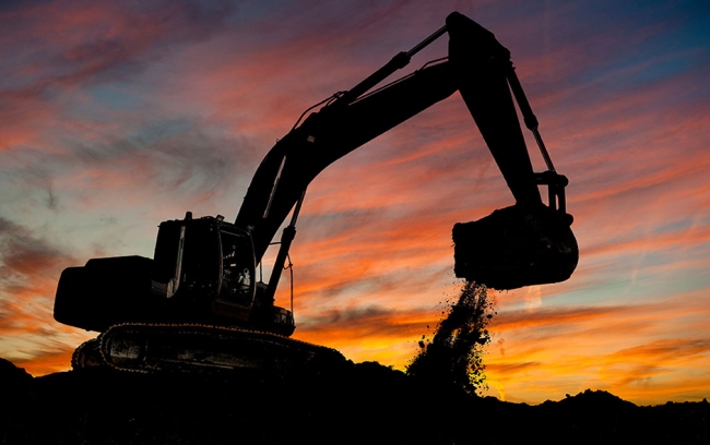 Showing a crane lifting dirt 