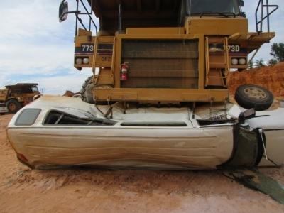 Accident scene where a haul truck driver pushed his supervisors car a distance of 30 to 40 feet with the driver inside.