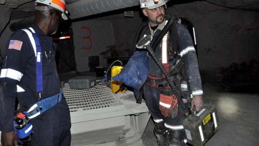 Two miners with gear getting ready to work
