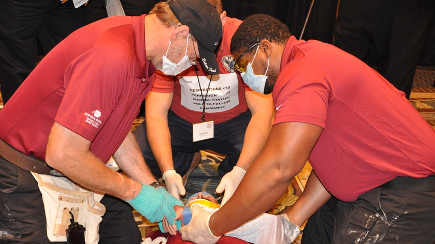 A team works to stabilize an injured miner before transport from the mine.