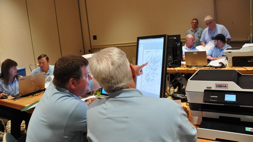Map reviewers scoring a mine rescue team’s map.
