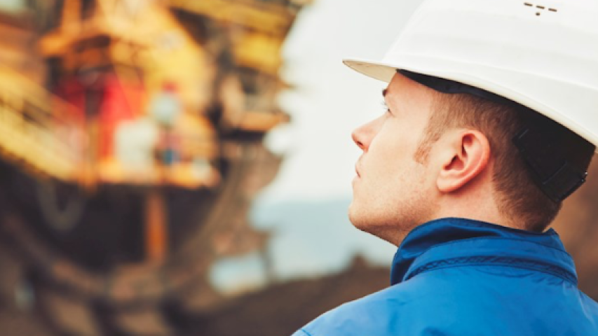 Mine inspector with a hardhat inspecting a mine